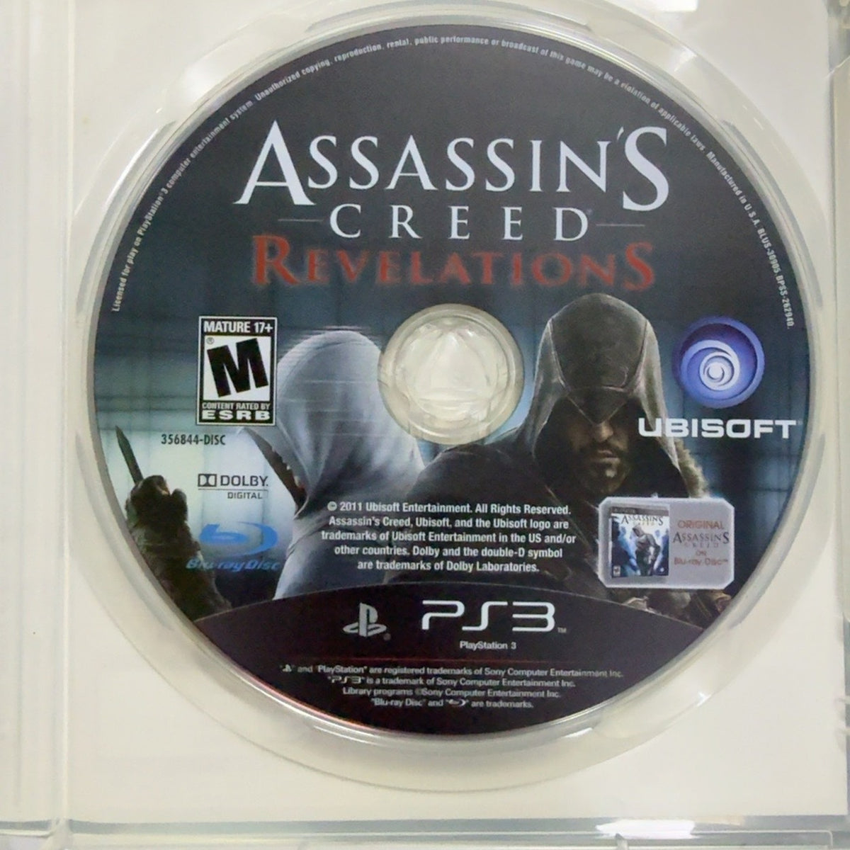 Fotografía real del disco de Assassin's Creed Revelations para PlayStation 3 usado